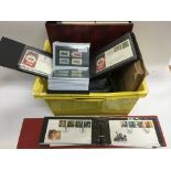 A crate of first day covers and GB stamps plus six framed unused pages of stamps.