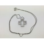 An 18ct white gold diamond set cross on an 18ct white gold chain, approx 5.5g.