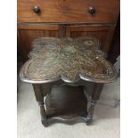 A carved oak occasional table with shaped top and undershelf, split top