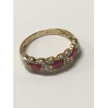 A 9ct gold ring set with a band of rubies and diamonds.Approx M, 2.1g