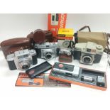 A box containing a collection of vintage cameras including Agfa and Kodak