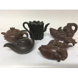 A collection of five Chinese terracotta late Republic tea pots in the form of fish and other