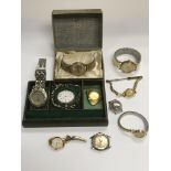 A silver pocket watch and various other watches.
