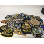 An Extensive collection of current American Police department badges and others over 70 badges