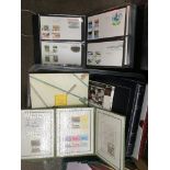 A box of stamps and first day covers in albums.