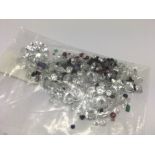 A bag of loose mixed stones including cubic zirconia, ruby, sapphire, amethyst and emerald. 91.43ct