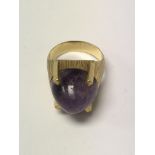 A contemporary ring inset with amethyst egg shaped stone.