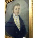 A pair of gilt framed Georgian portraits depicting a gentleman and lady .29 cm by 35 cm .