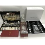 A boxed Royal Doulton decanter and glasses set, two decanters and a cased cutlery set.