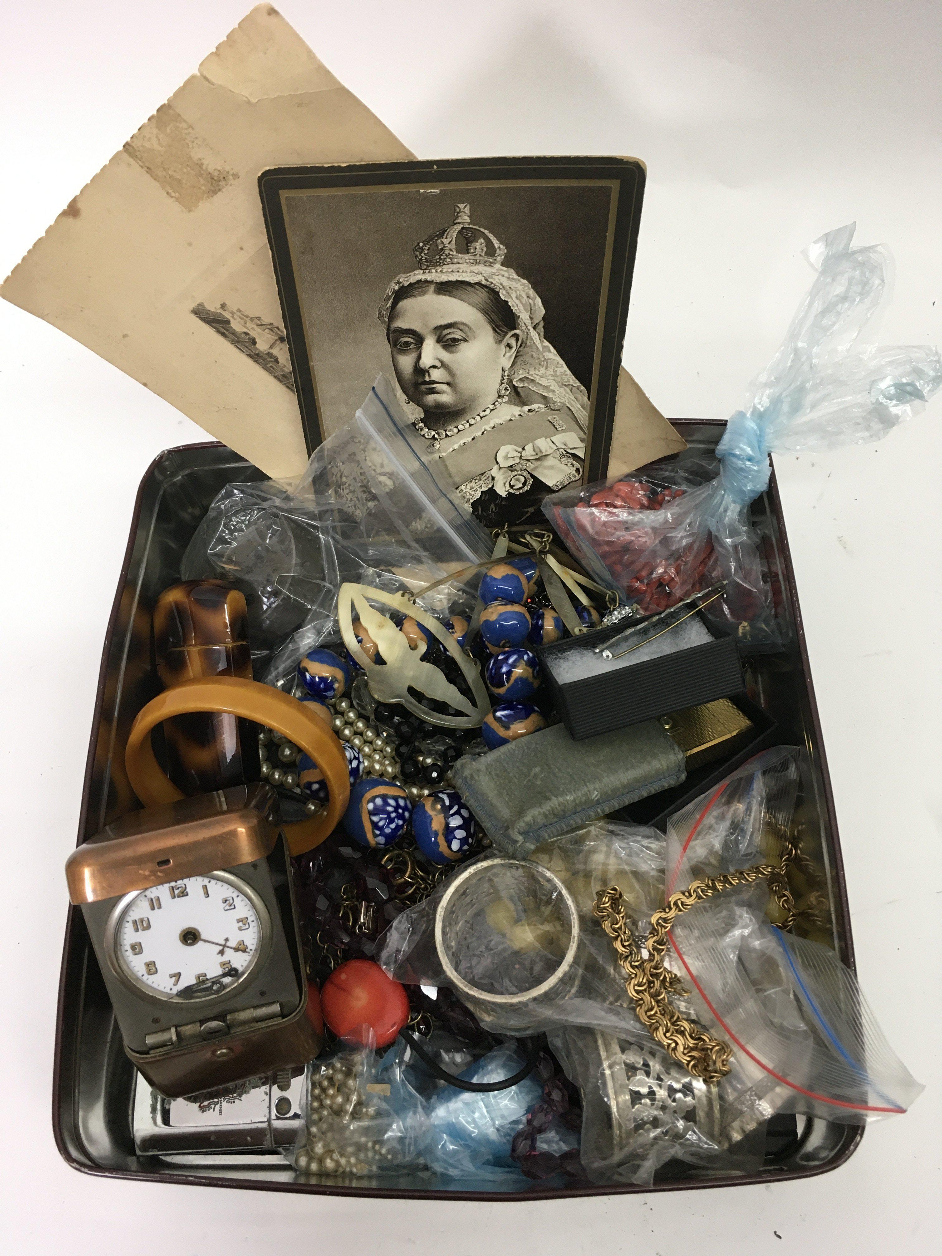 A tin containing costume jewellery and odds - NO R