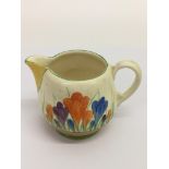 A small Clarice Cliff 'Crocus' pattern jug.Approx 8cm, possible restoration to spout.