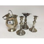 A pair of white metal candle sticks a conforming s