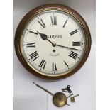 A station clock with painted dial bearing the name 'G.Lumer, Chingford', with pendulum and key