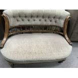 A pair of Victorian walnut sofas with spindle backs button back upholstery on fluted legs together