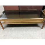 A 1970s glass top coffee table