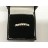 An 18ct white gold full eternity set with banded diamonds, approx .08pt, size P.