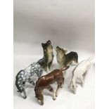 A group of Russian Lomonosov porcelain models of wolves and horses, larger sizes No damage or