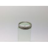 A 14k white gold diamond set half eternity ring, a