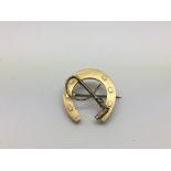 A 9ct gold horseshoe brooch, approx 2.5g.