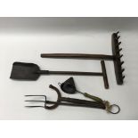 A collection of fireside tools to include a toasting fork.