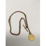 A 1906 half sovereign on 9ct rose gold fob chain,