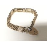 A 9carat gold gate bracelet with a padlock clasp. Weight 14g.