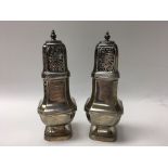 A pair of silver sugar casters, hallmarked for Lon