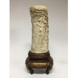 A Japanese 19 th century ivory tusk carving set on a lacquered stand finely detailed with dragon and