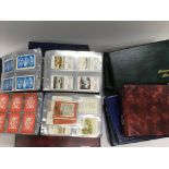 A collection in nine albums of various sets of playing card plus a an album of vintage postcrads.