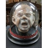 A pottery child’s head under glass dome A/F
