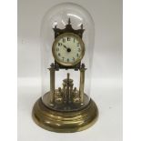 A brass anniversary clock under glass dome.Approx