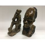 Two carved stone African ornamental items comprising a bust of a bearded gentleman and one other.