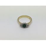 An 18ct gold ring set with a central emerald with a diamond either side, approx 4.2 g and approx