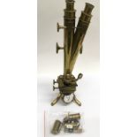 A brass microscope with duel eyepiece