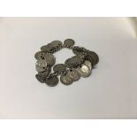 A silver coin bracelet.