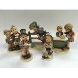 Five Hummel figures of children including some 1960s examples.