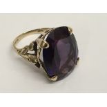 A 9ct gold ring set with large amethyst colour stone.Approx K