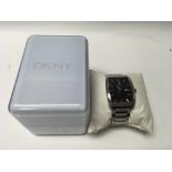 A boxed gentleman's DKNY watch on a stainless stee