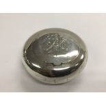 A circular silver tobacco box, Birmingham hallmarks.