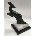 A car mascot of a leaping deer raised on a stepped base, approx height 16cm. Some damage.