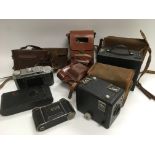 A collection of vintage cameras and accessories.