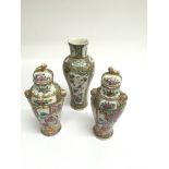 A Chinese, Canton porcelain vase garniture,painted with figures at court. Largest approx 27cm,