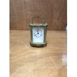 An oval brass and 4 glass carriage clock