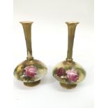 A pair of Worcester slender necked vases, painted with roses.Approx 19cm, restored.