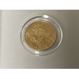 An American proof gold coin 1/10 OZ fine gold five dollar in a Perspex case.