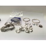 A collection of silver rings and bracelets