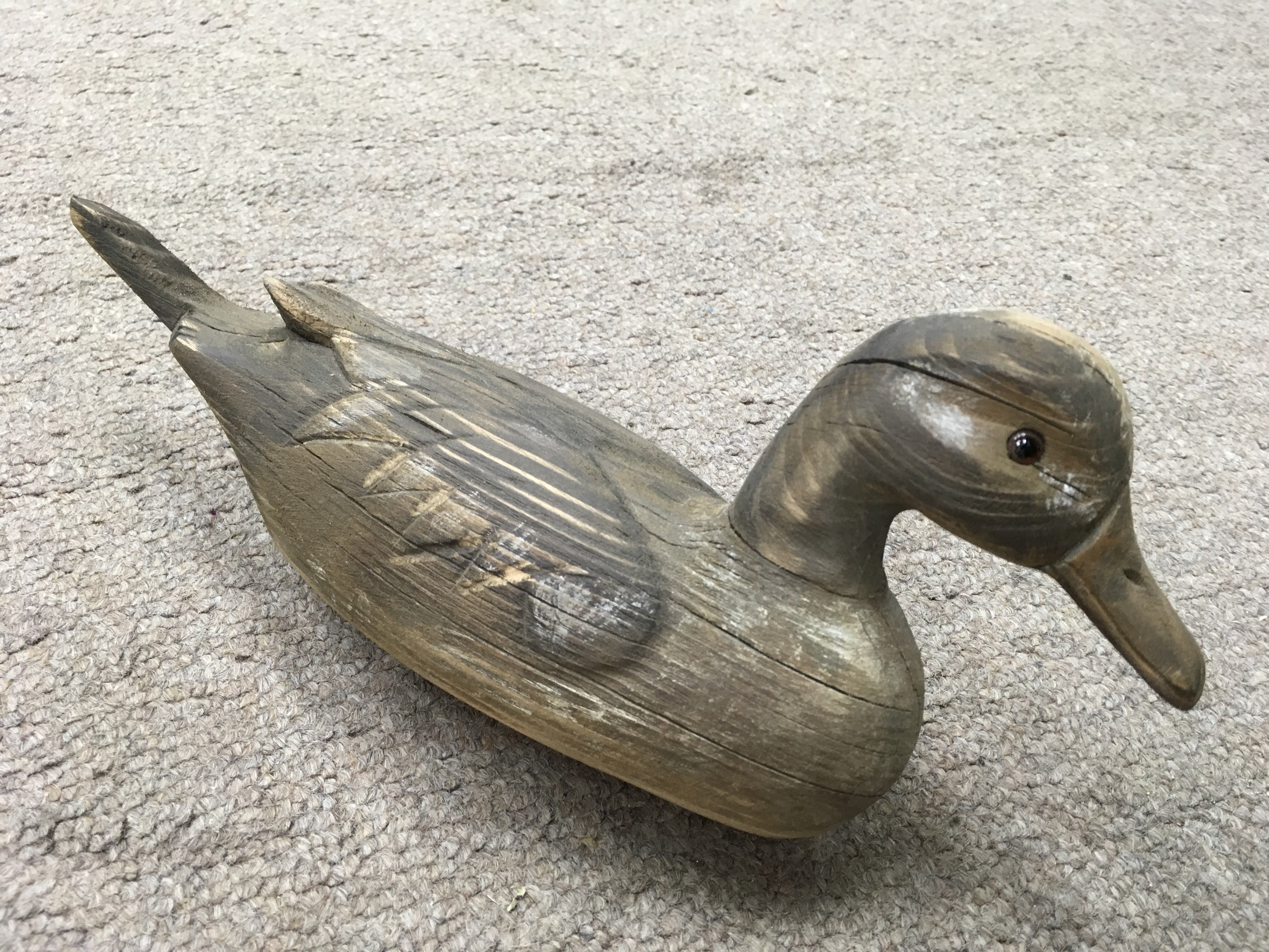 A small wooden decoy styled duck