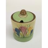 A Clarice Cliff 'Green Crocus' preserve pot.Approx 10cm, damage and restoration.