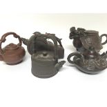 A collection of five Chinese terracotta late Republic tea pots in the form of dragons and other