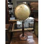 A modern globe on a turned wood base with internal